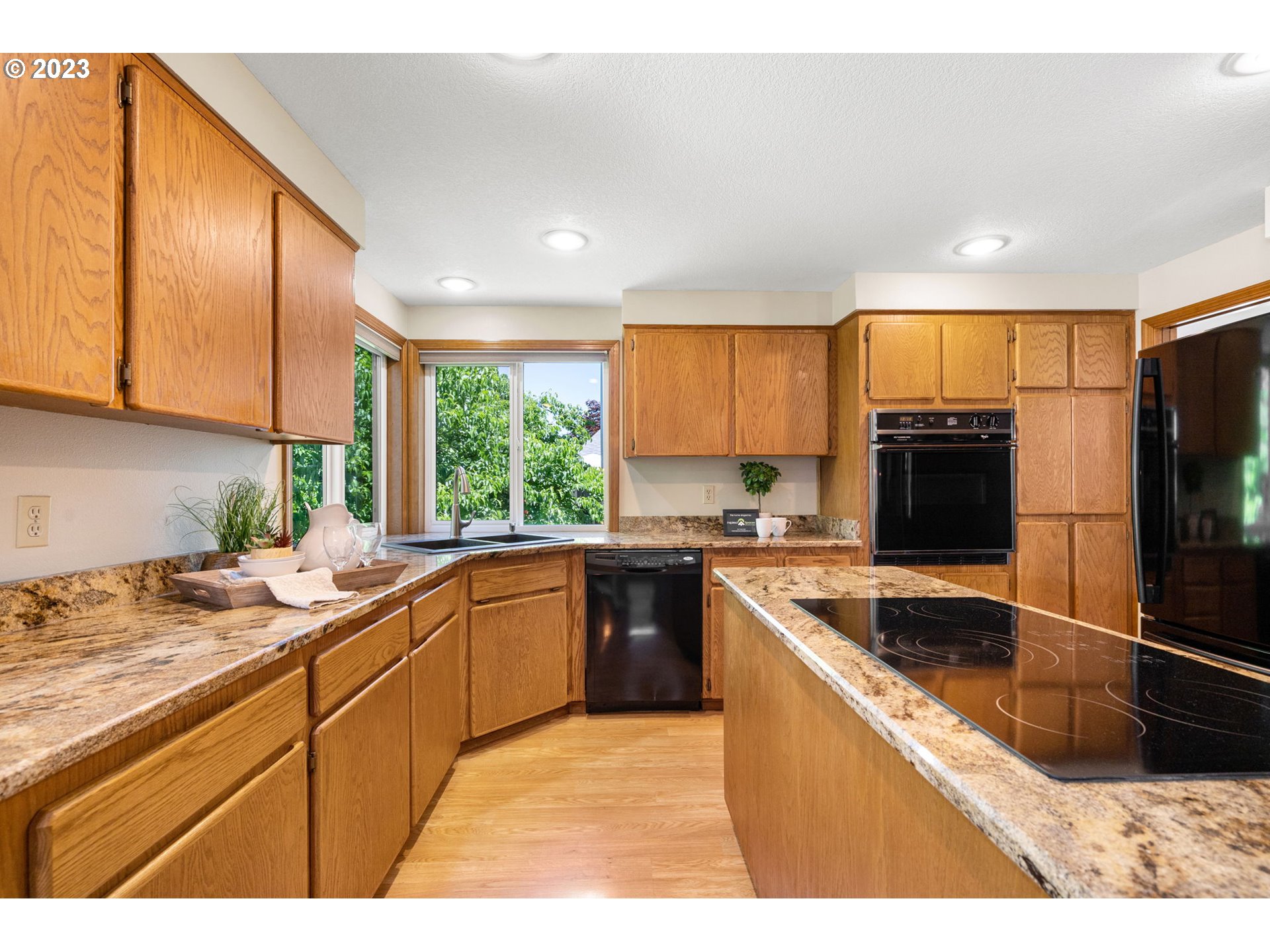 9062 Southwest Hill Street Portland, OR 97223 - Photo 11 of 48 a kitchen with a sink stove and refrigerator