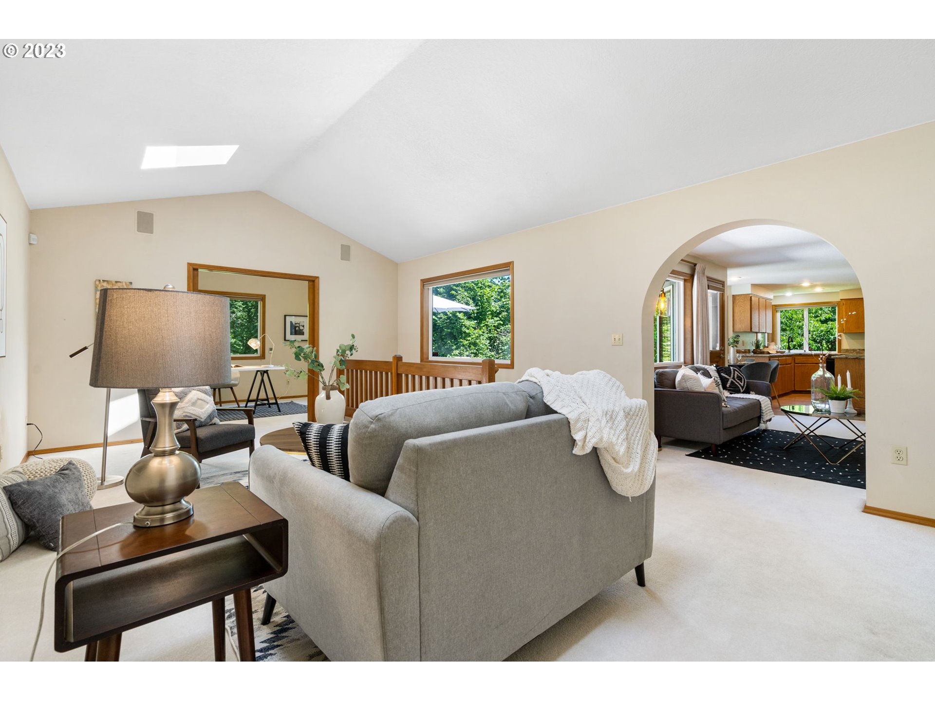 9062 Southwest Hill Street Portland, OR 97223 - Photo 21 of 48 a living room with furniture a lamp a rug and a large window