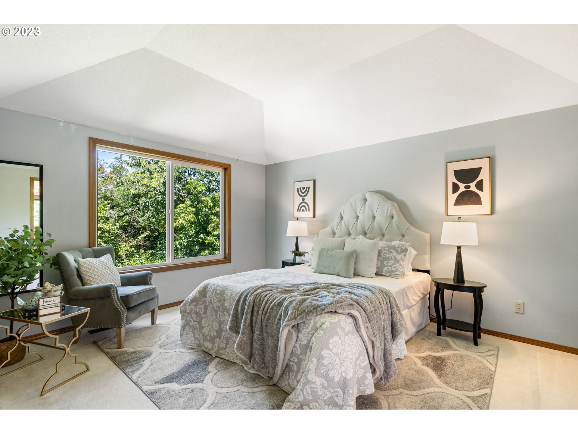 9062 Southwest Hill Street Portland, OR 97223 - Photo 24 of 48 a bedroom with a bed a large window with table and chair