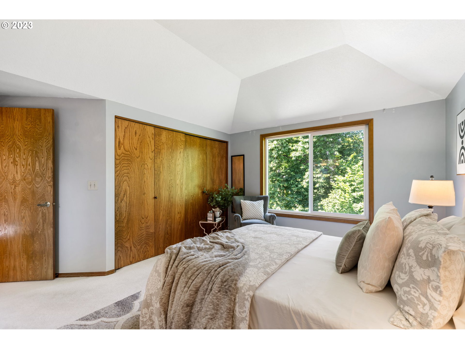 9062 Southwest Hill Street Portland, OR 97223 - Photo 25 of 48 a bedroom with a bed and a large window