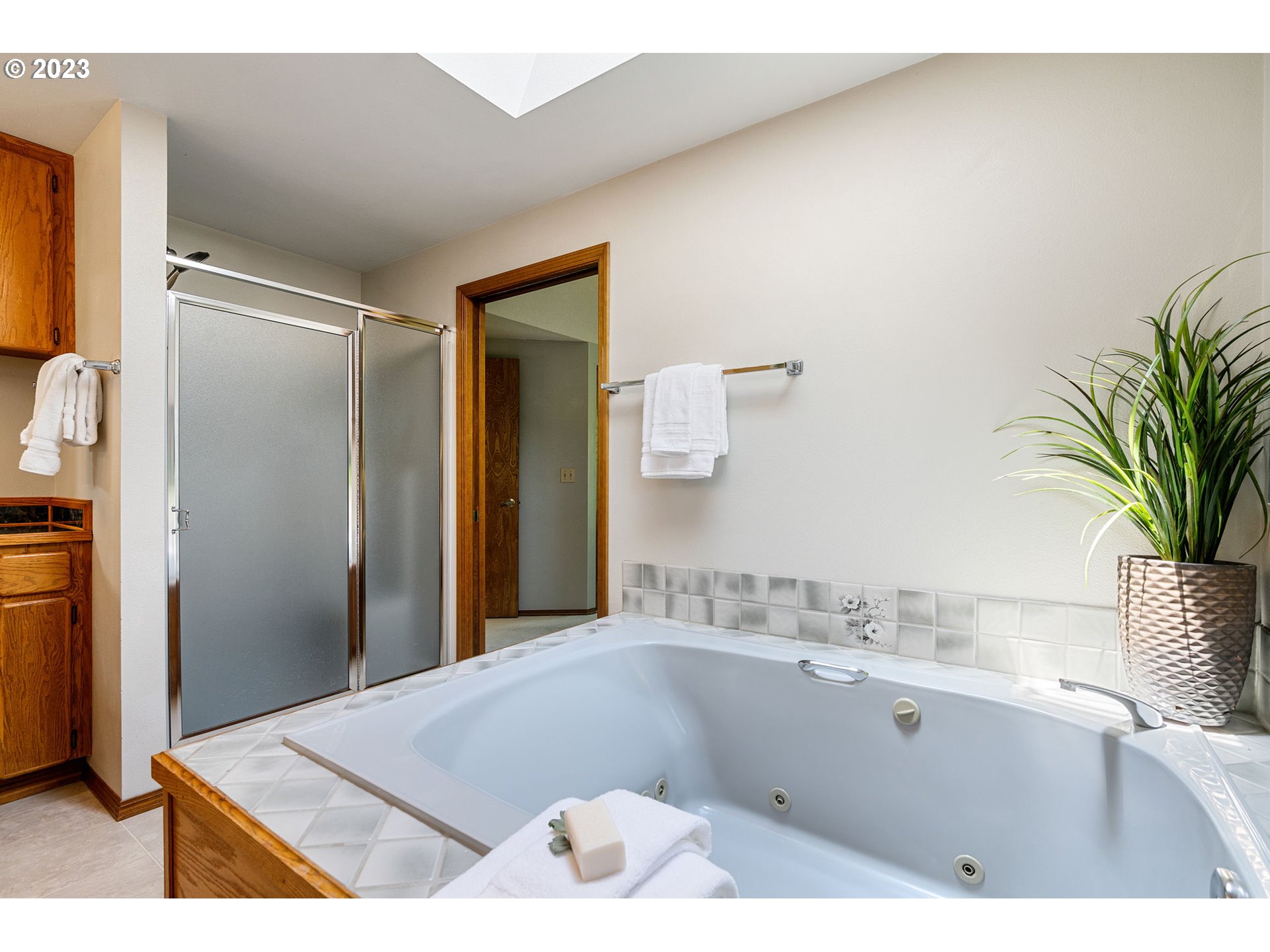 9062 Southwest Hill Street Portland, OR 97223 - Photo 28 of 48 a bathroom with a tub sink and mirror