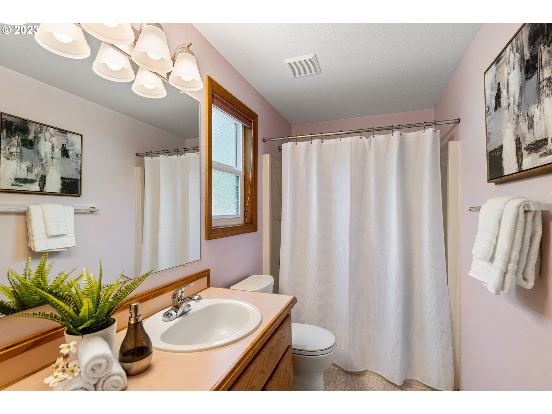 9062 Southwest Hill Street Portland, OR 97223 - Photo 31 of 48 a bathroom with a sink toilet and a mirror