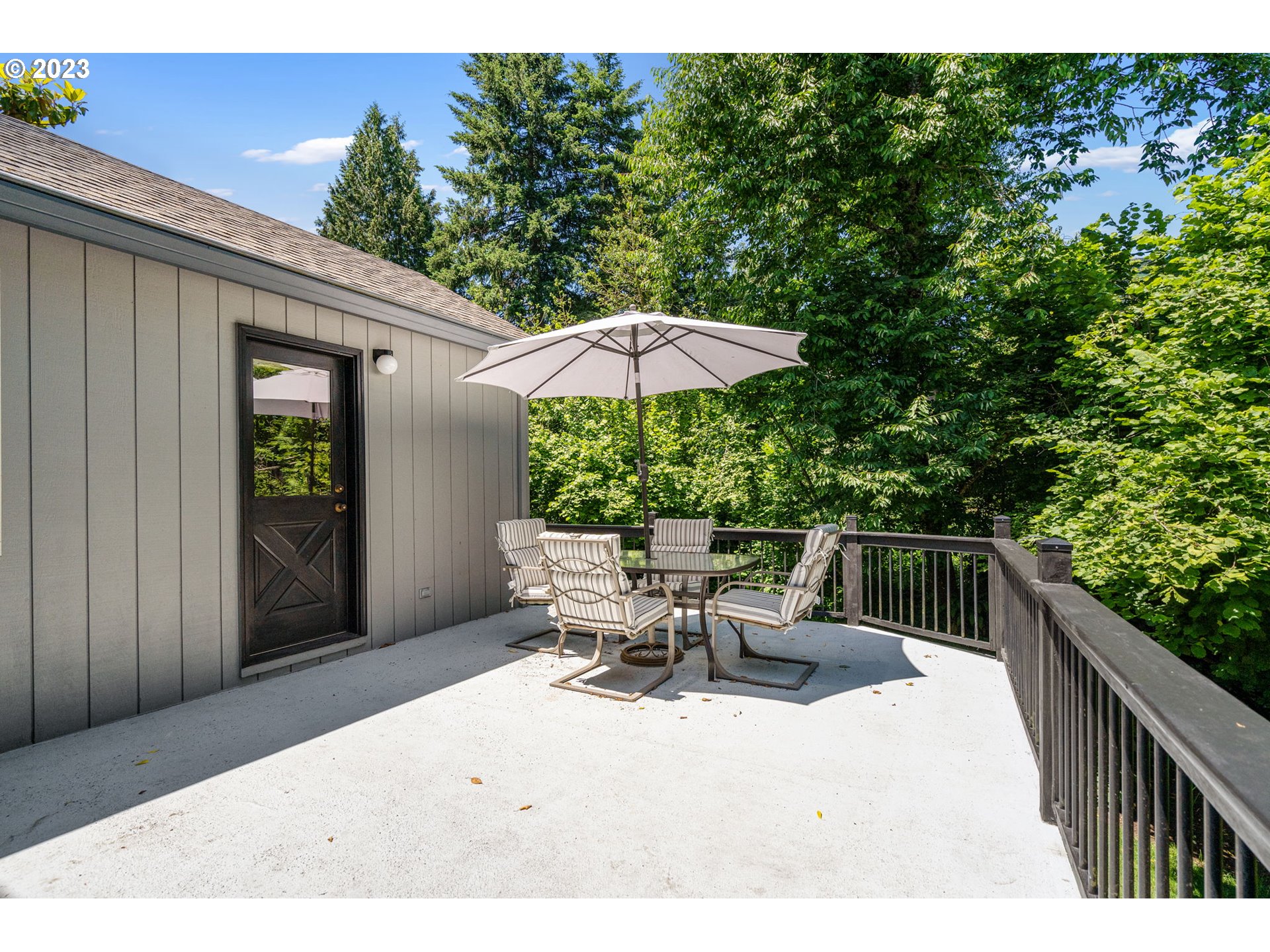 9062 Southwest Hill Street Portland, OR 97223 - Photo 37 of 48 a terrace with outdoor seating and wooden floor
