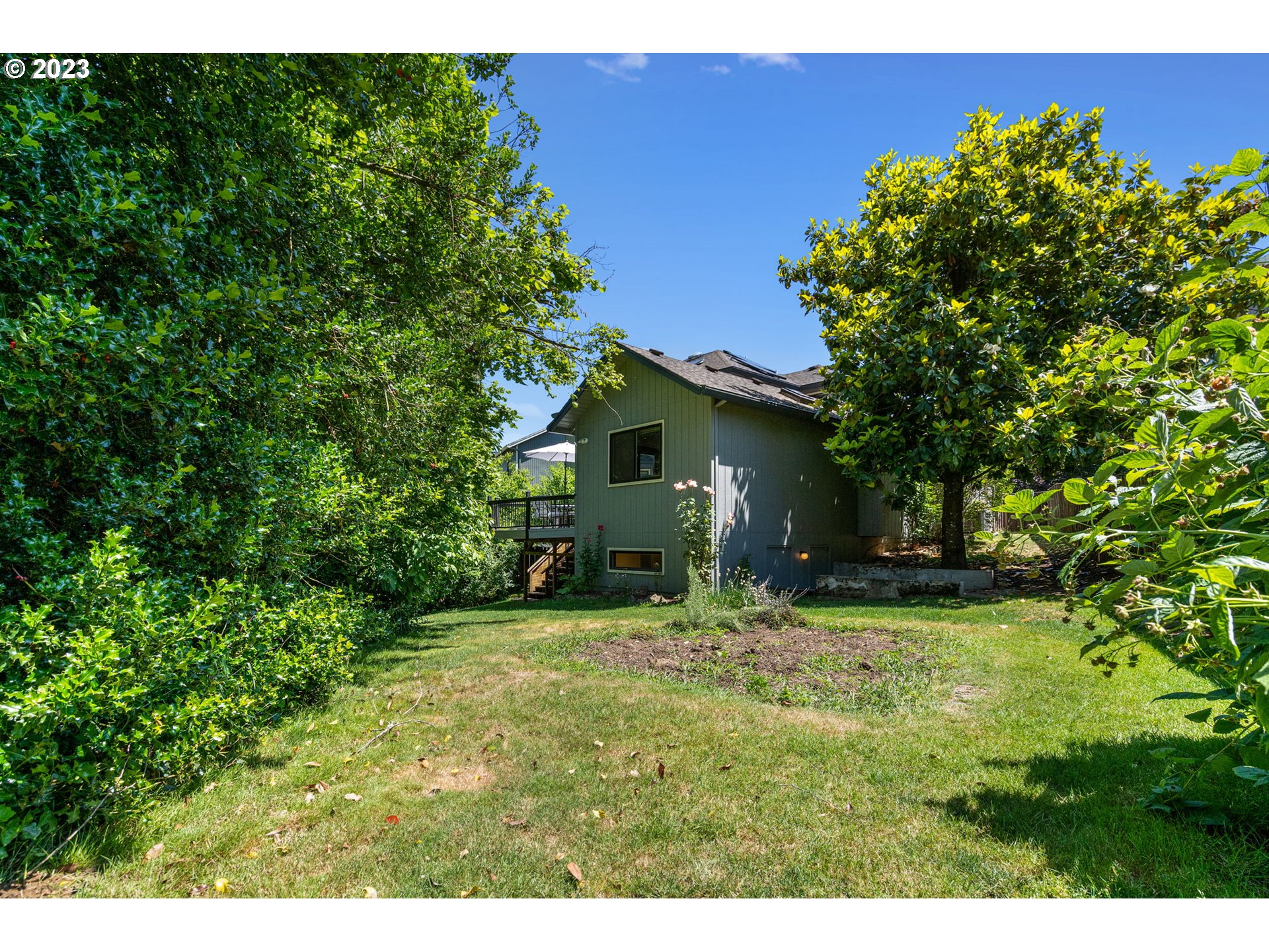 9062 Southwest Hill Street Portland, OR 97223 - Photo 43 of 48 a backyard of a house with table and chairs