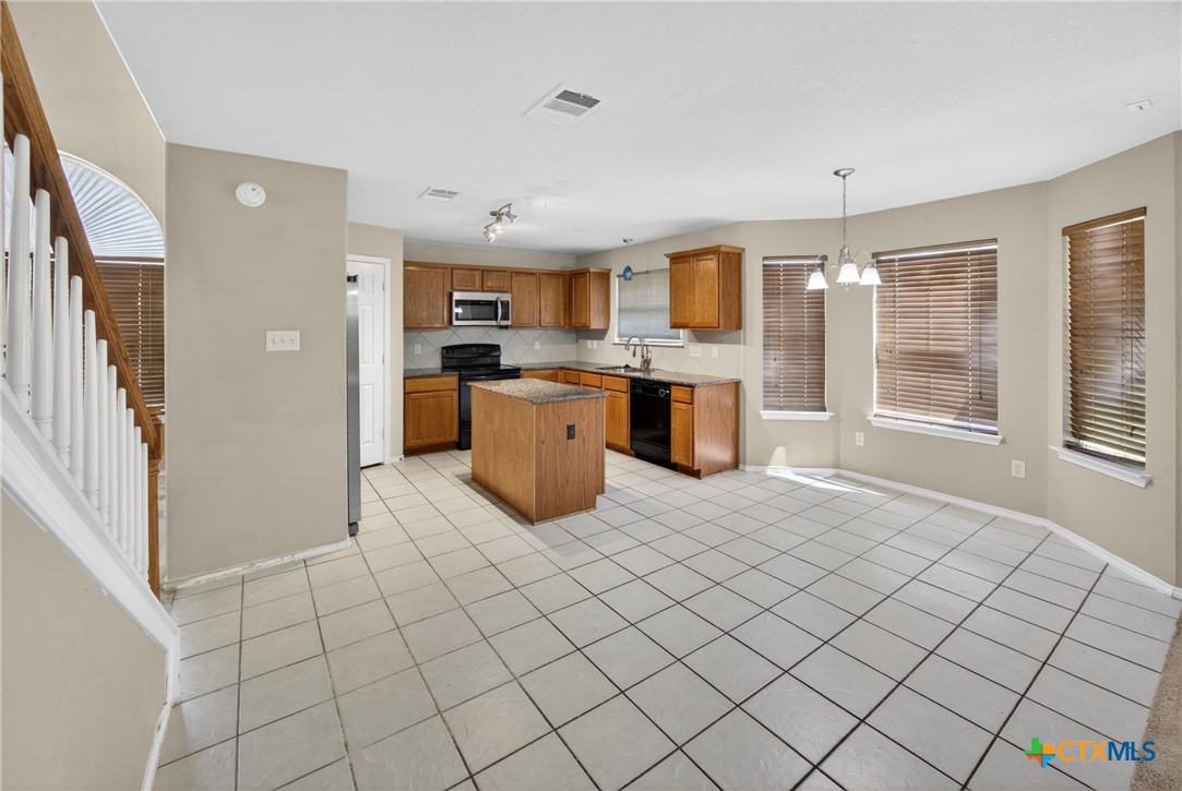 7015 Rickey Drive Temple, TX 76502 - Photo 8 of 29 a large white kitchen with cabinets