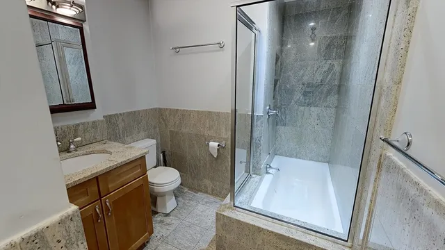 a bathroom with a sink toilet and shower