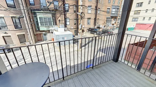 a view of a balcony with wooden floor