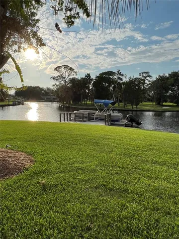 a view of a lake with houses in back