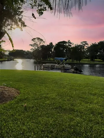 a swimming pool with trees in the background