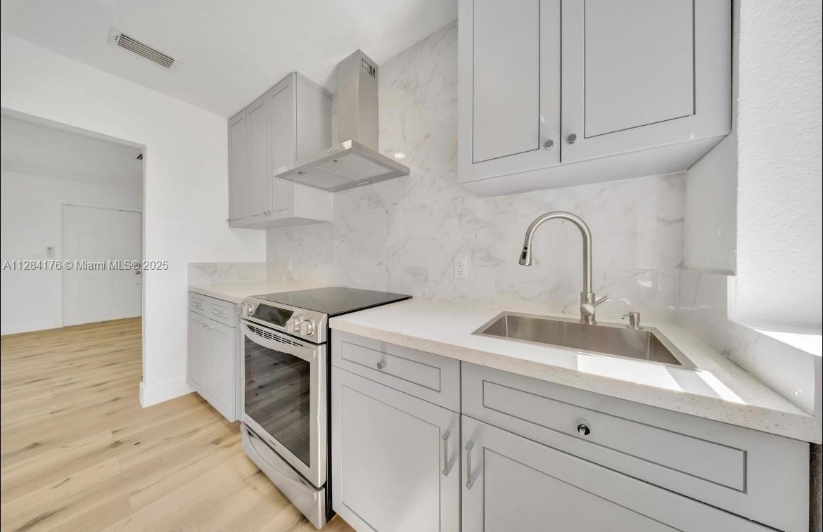 782 East 37th Street Hialeah, FL 33013 - Photo 4 of 46 a kitchen with white cabinets appliances and a sink