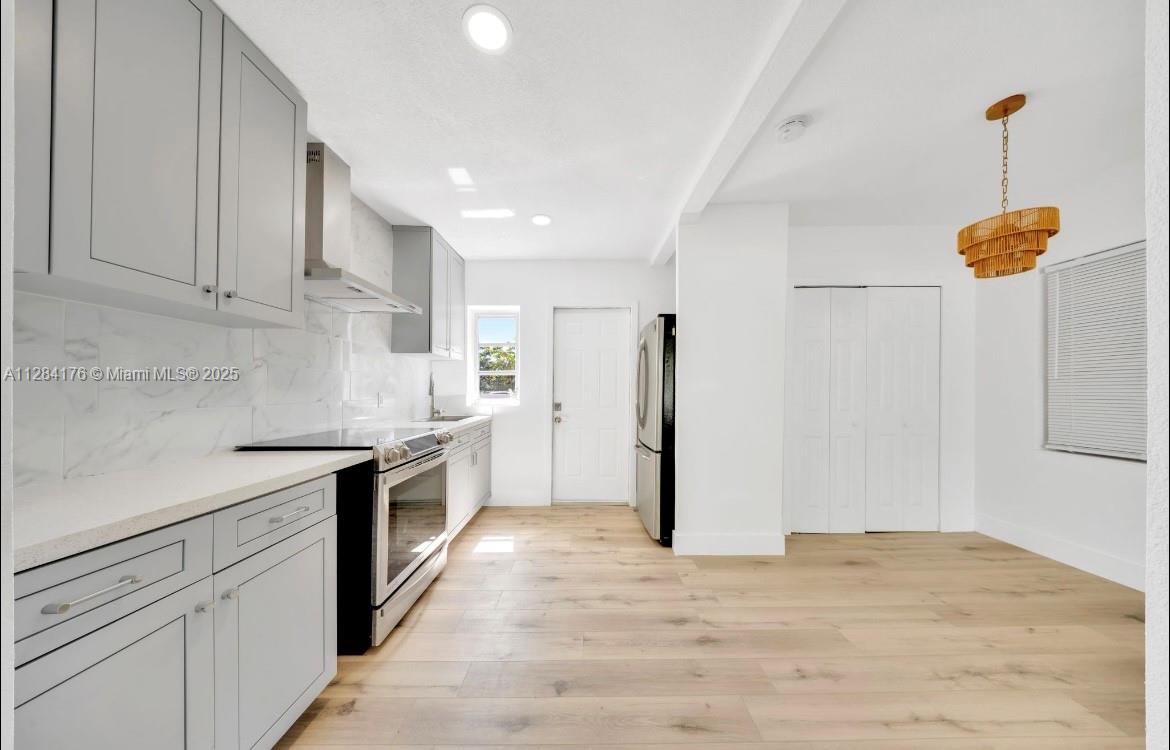 782 East 37th Street Hialeah, FL 33013 - Photo 6 of 46 a kitchen with a refrigerator and white cabinets