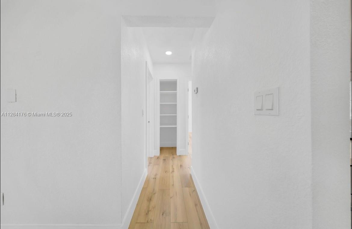 782 East 37th Street Hialeah, FL 33013 - Photo 10 of 46 a view of a hallway with wooden floor