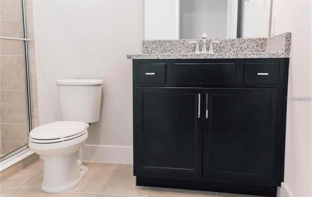 6824 Bridgman Street Orlando, FL 32827 - Photo 11 of 19 a bathroom with a granite countertop sink and a toilet