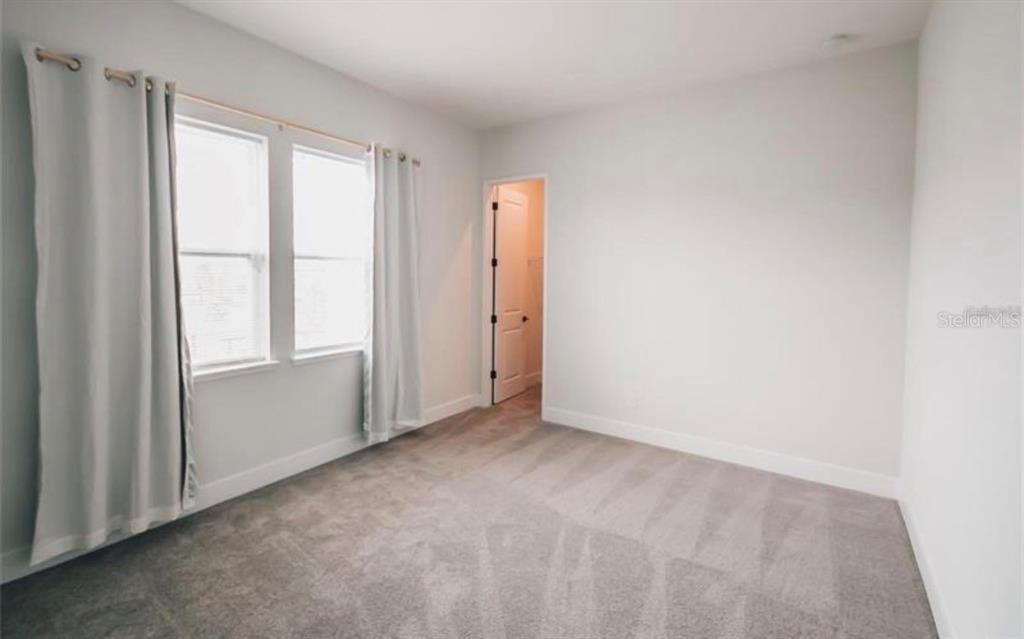 6824 Bridgman Street Orlando, FL 32827 - Photo 8 of 19 an empty room with windows and closet