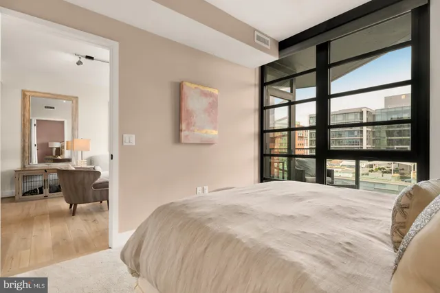 a large bedroom with a large bed and a large window