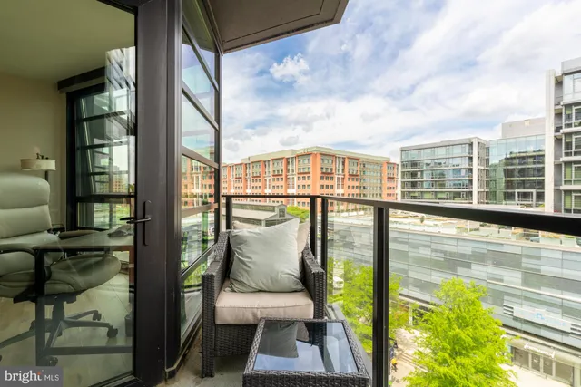 a view of a balcony with floor to ceiling windows and wooden floor
