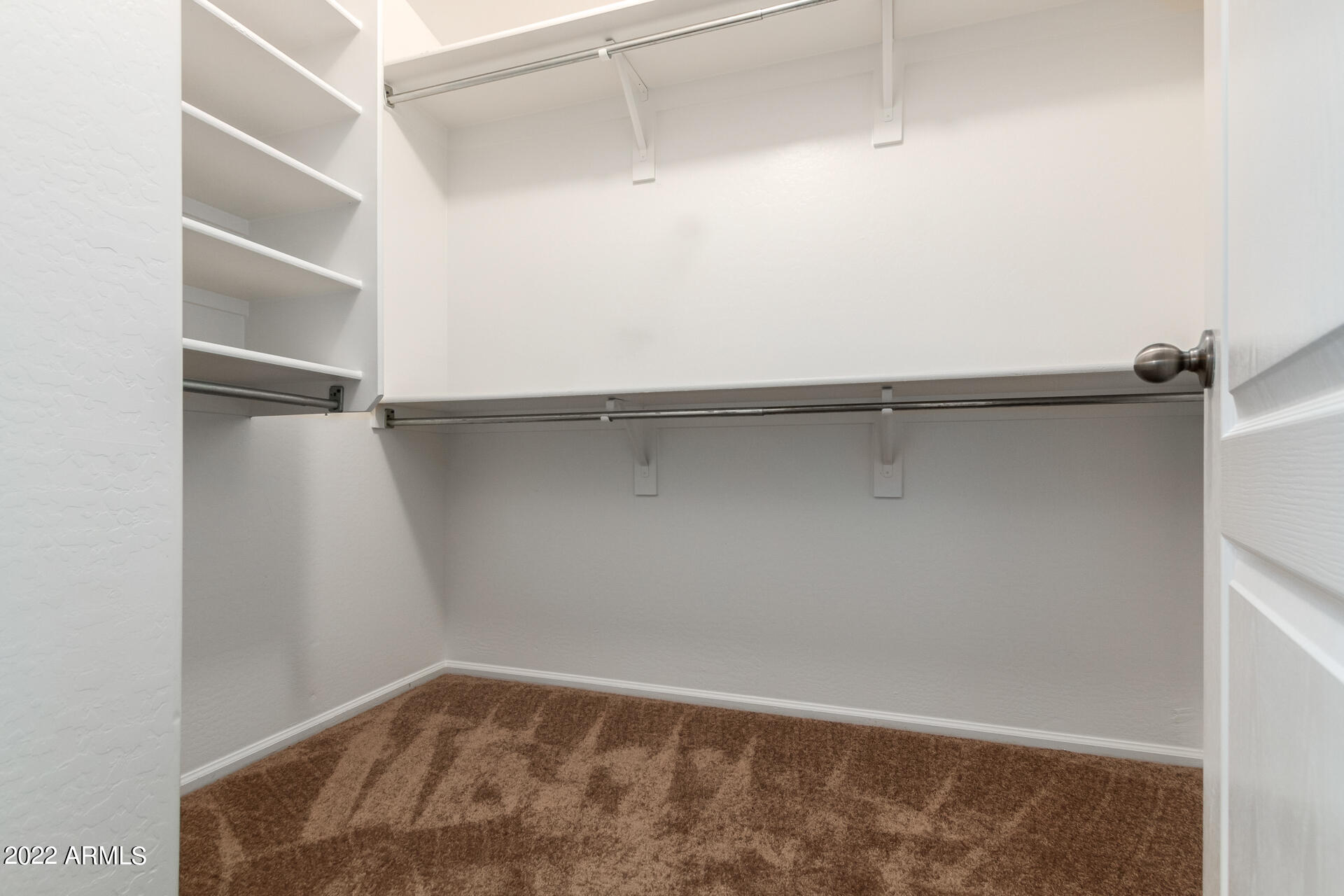 9123 West Heber Road Tolleson, AZ 85353 - Photo 12 of 41 a view of an empty walk in closet