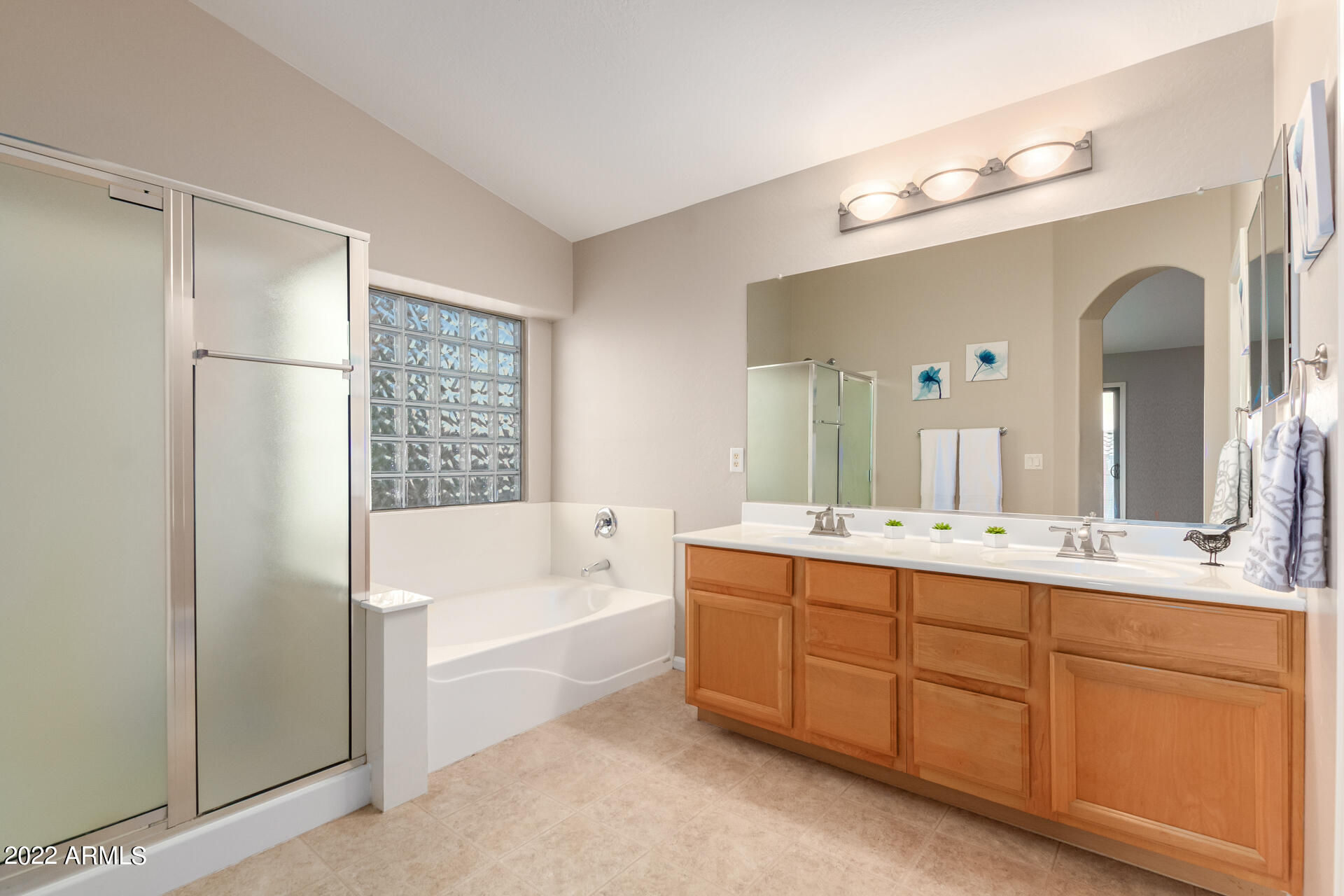 9123 West Heber Road Tolleson, AZ 85353 - Photo 28 of 41 a bathroom with a tub a sink double vanity and a mirror