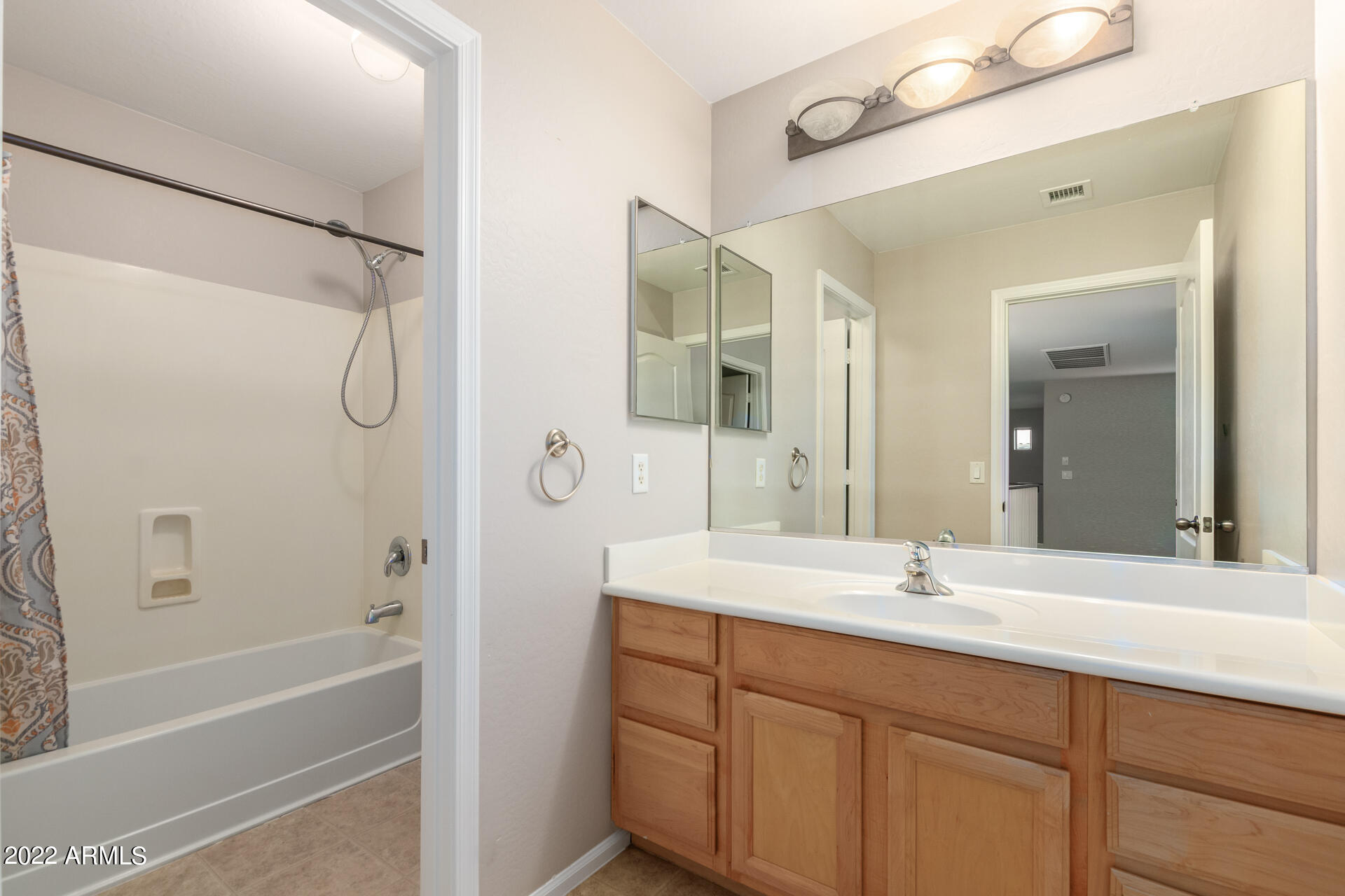 9123 West Heber Road Tolleson, AZ 85353 - Photo 34 of 41 a bathroom with a double vanity sink mirror double and shower