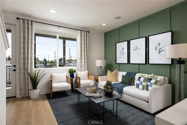 a living room with furniture a flat screen tv and a large window