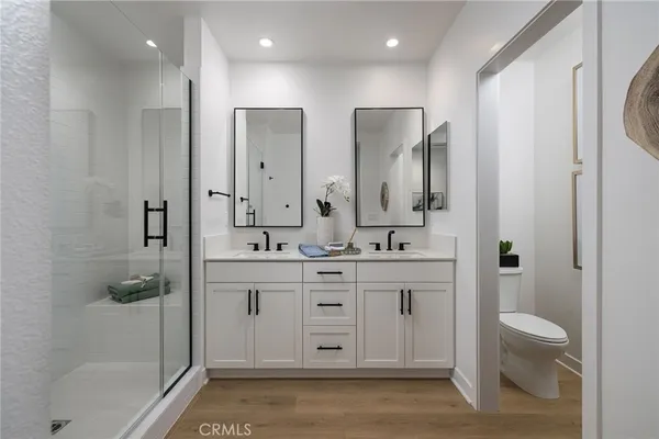 a bathroom with a sink mirror vanity and toilet