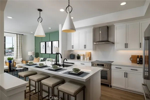 a kitchen with a refrigerator and a stove top oven