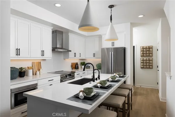 a kitchen with a sink a stove and a refrigerator