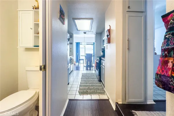 a view of a hallway with a livingroom and a bathroom