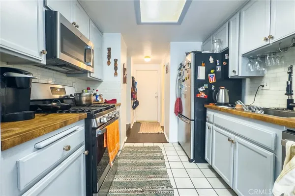a kitchen with stainless steel appliances granite countertop a refrigerator and a stove