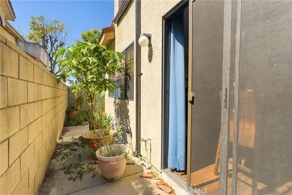 a view of a balcony with chair and potted plants