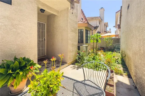 a balcony with table and chairs
