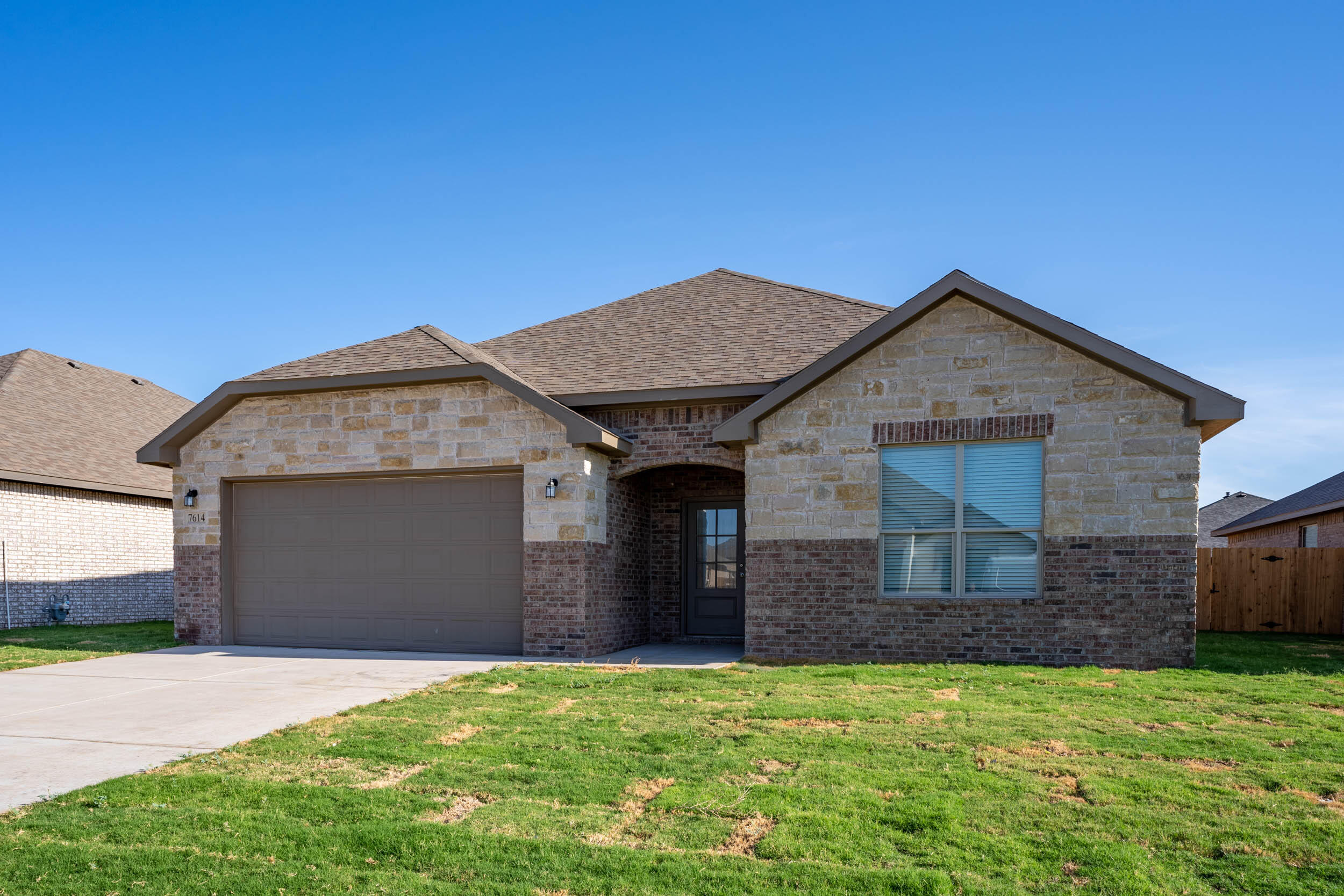 7602 60th Street Lubbock, TX 79407 - Photo 3 of 24 a front view of a house with garden