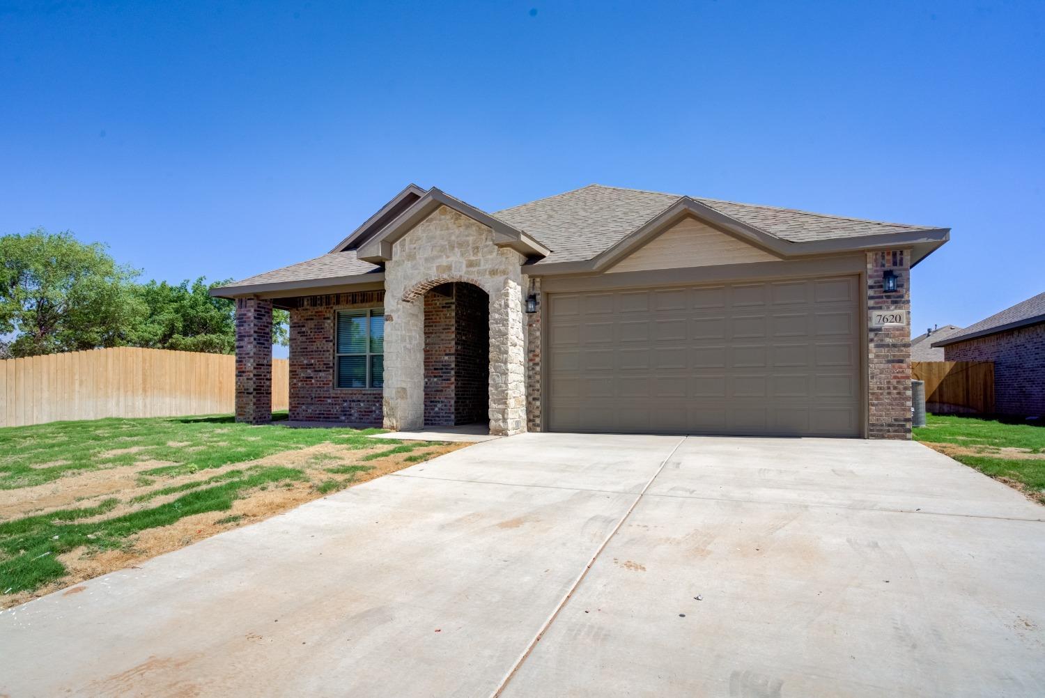 7602 60th Street Lubbock, TX 79407 - Photo 4 of 24 a front view of a house with a yard