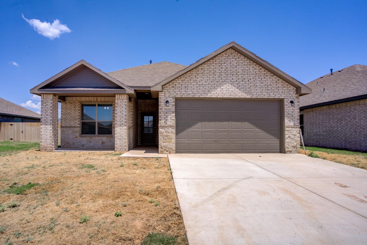 7602 60th Street Lubbock, TX 79407 - Photo 5 of 24 a front view of a house with yard