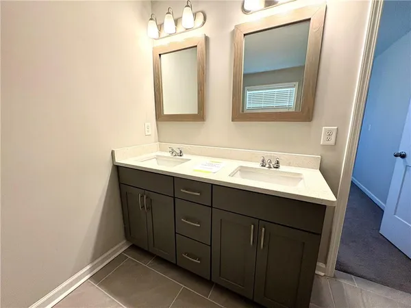 a bathroom with a double vanity sink and mirror