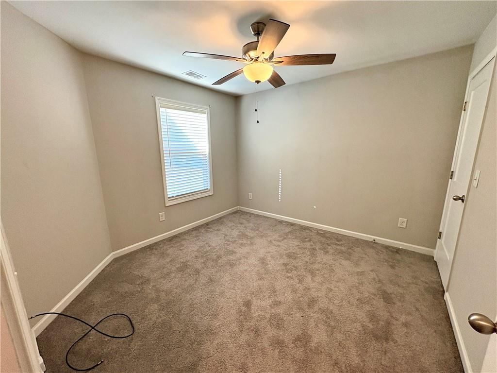 248 Webster Lake Drive Temple, GA 30179 - Photo 17 of 29 an empty room with a window and a ceiling fan