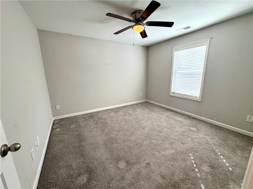 248 Webster Lake Drive Temple, GA 30179 - Photo 18 of 29 an empty room with windows and fan