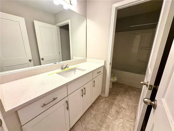 a bathroom with a double vanity sink and a mirror