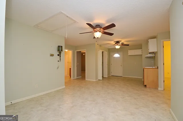 an empty room with a bathroom and a shower