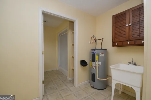 a bathroom with a granite countertop sink a toilet and a mirror