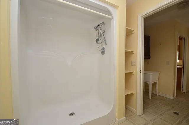 a bathroom with a glass shower door