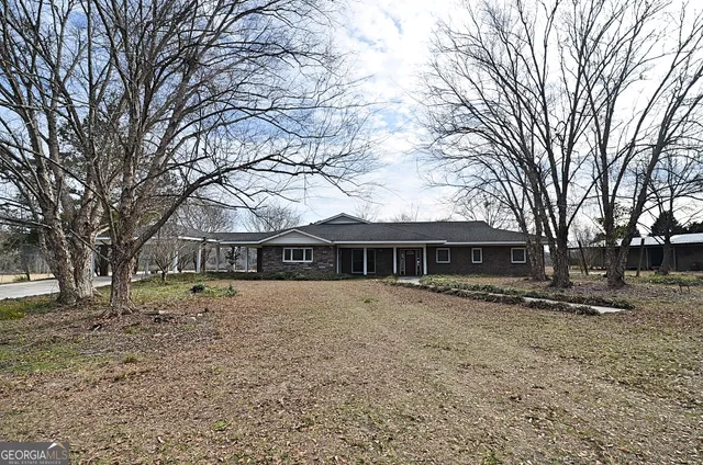 a front view of house with yard covered in tree