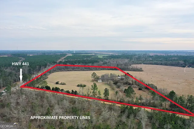 a view of swimming pool with red and white wooden fence
