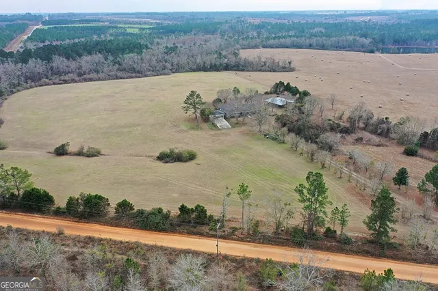 an aerial view of a house with a yard