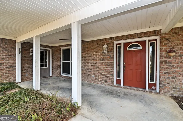 front view of a brick house with a large door