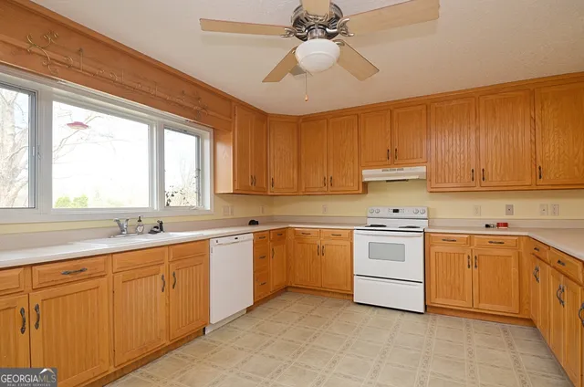 a kitchen with a sink cabinets and window
