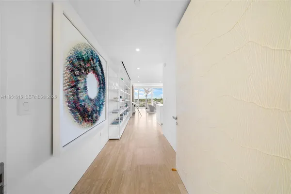 a view of a hallway and wooden floor