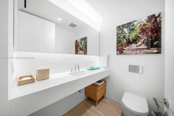 a bathroom with a toilet a sink and mirror