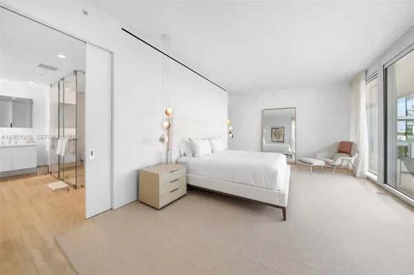 a spacious bedroom with a bed and a couch