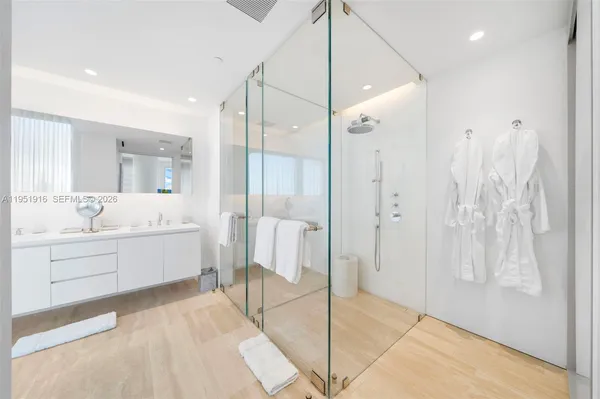 a bathroom with a double vanity sink mirror and shower